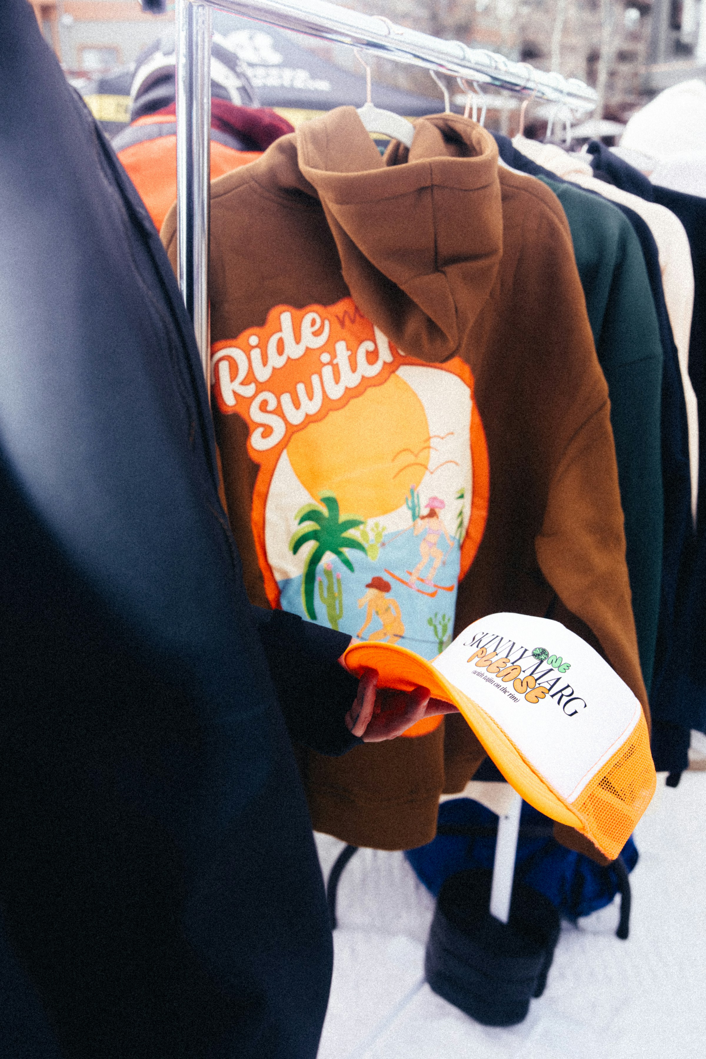 The selected photograph shows clothing on a rack; it is contextual imagery, not a documented swap event.